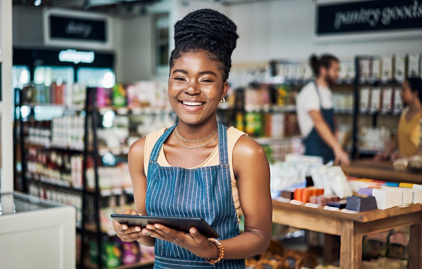 A shop owner using a tablet to manage a business